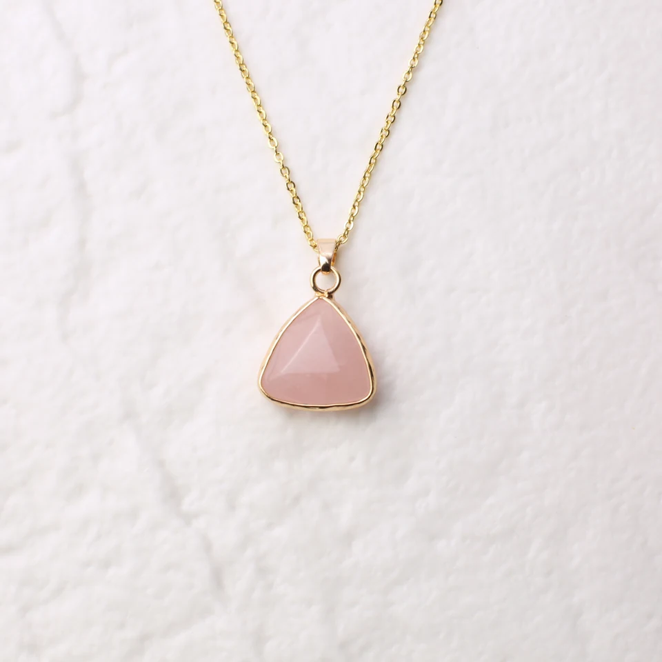Petite triangle rose quartz pendant necklace in the seller-edited square Drive photo.